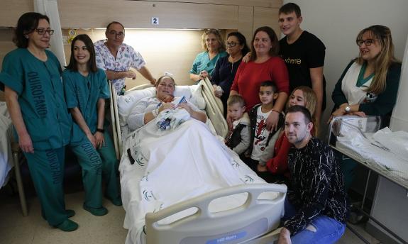 Nursing staff and family surround little Adil. 
