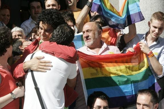 Pedro Zerolo (left) embraces his partner during celebrations in Madrid as the law comes into effect.