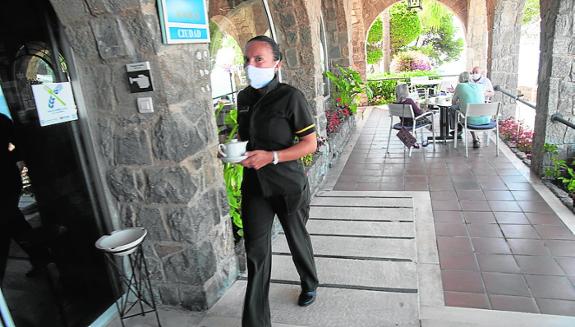 A worker at a hotel in Malaga this summer after reopening.