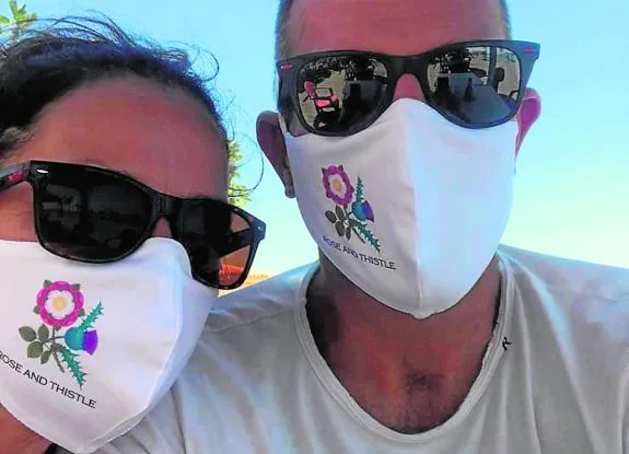 Sarah and Simon Dearing sporting Rose and Thistle masks. 