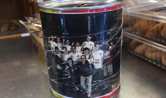 One of the collecting tins in a local shop tor aise funds for the family.