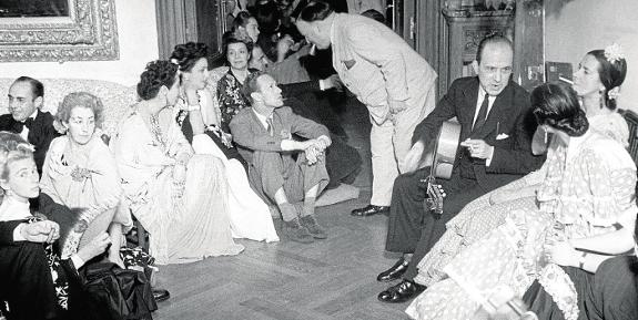  Walter Starkie (standing) talks to actor Leslie Howard at one of the famous flamenco parties at the institute in Madrid in 1943.