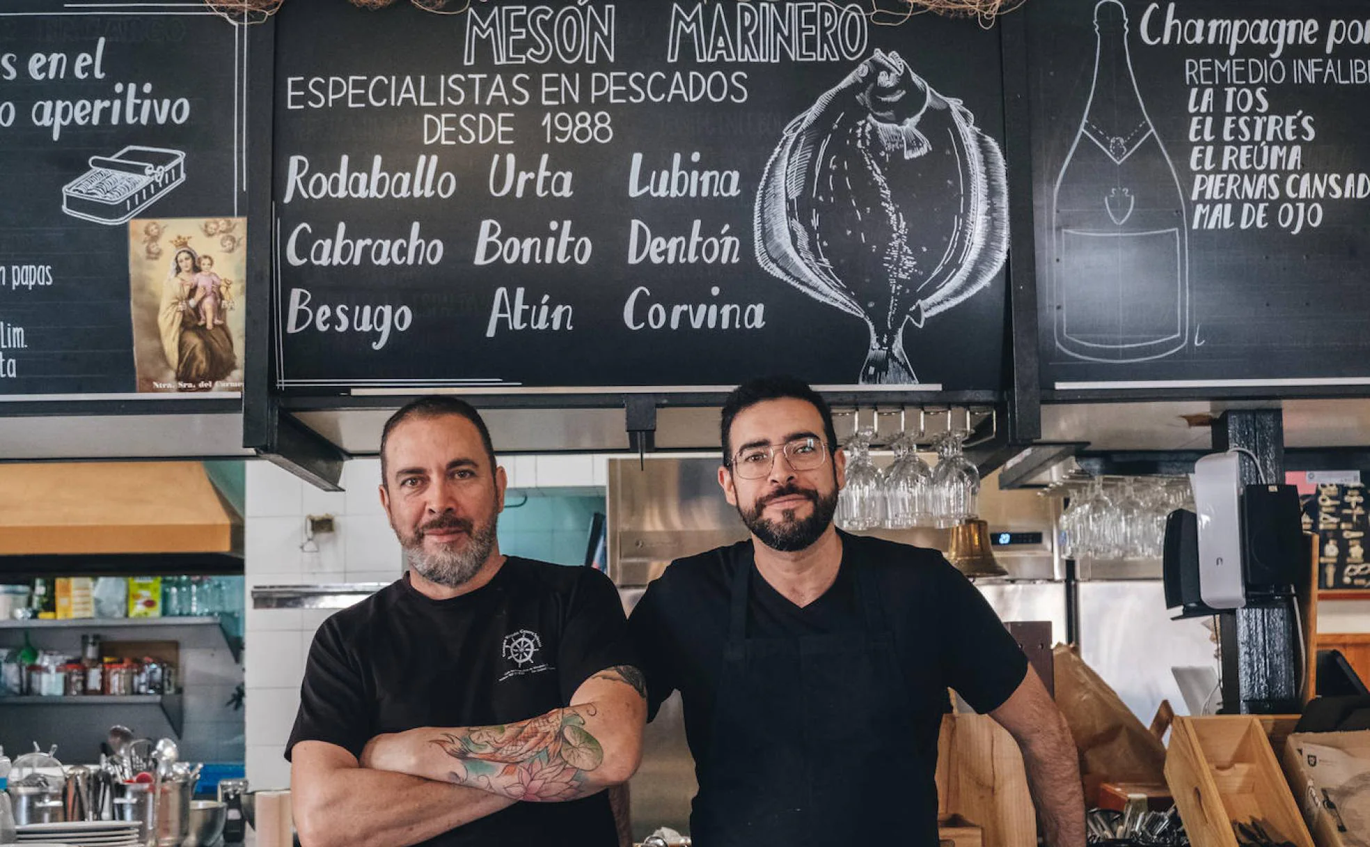 Julio y Javier, dueños del mesón posando en la barra del restaurante fundado en 1988