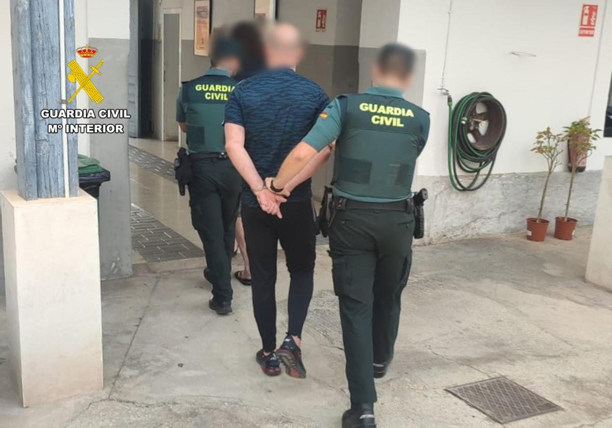 Agentes de la Guardia Civil detienen a uno de los sospechosos.