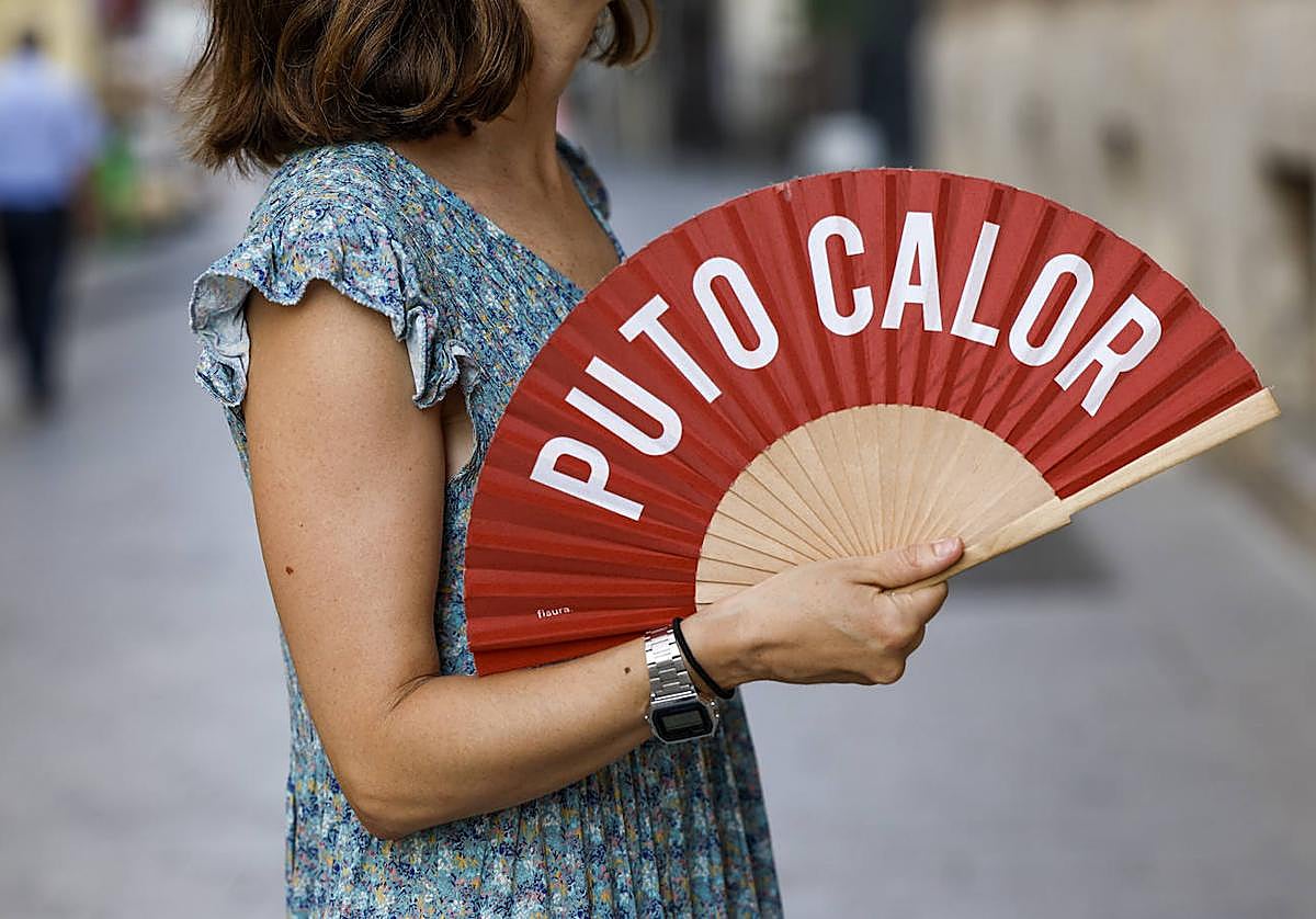 Una mujer combate el calor antes de la llegada de las lluvias al norte de Alicante.
