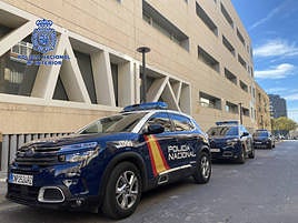 Coches de la Policía Nacional en la puerta de la comisaría en Alicante