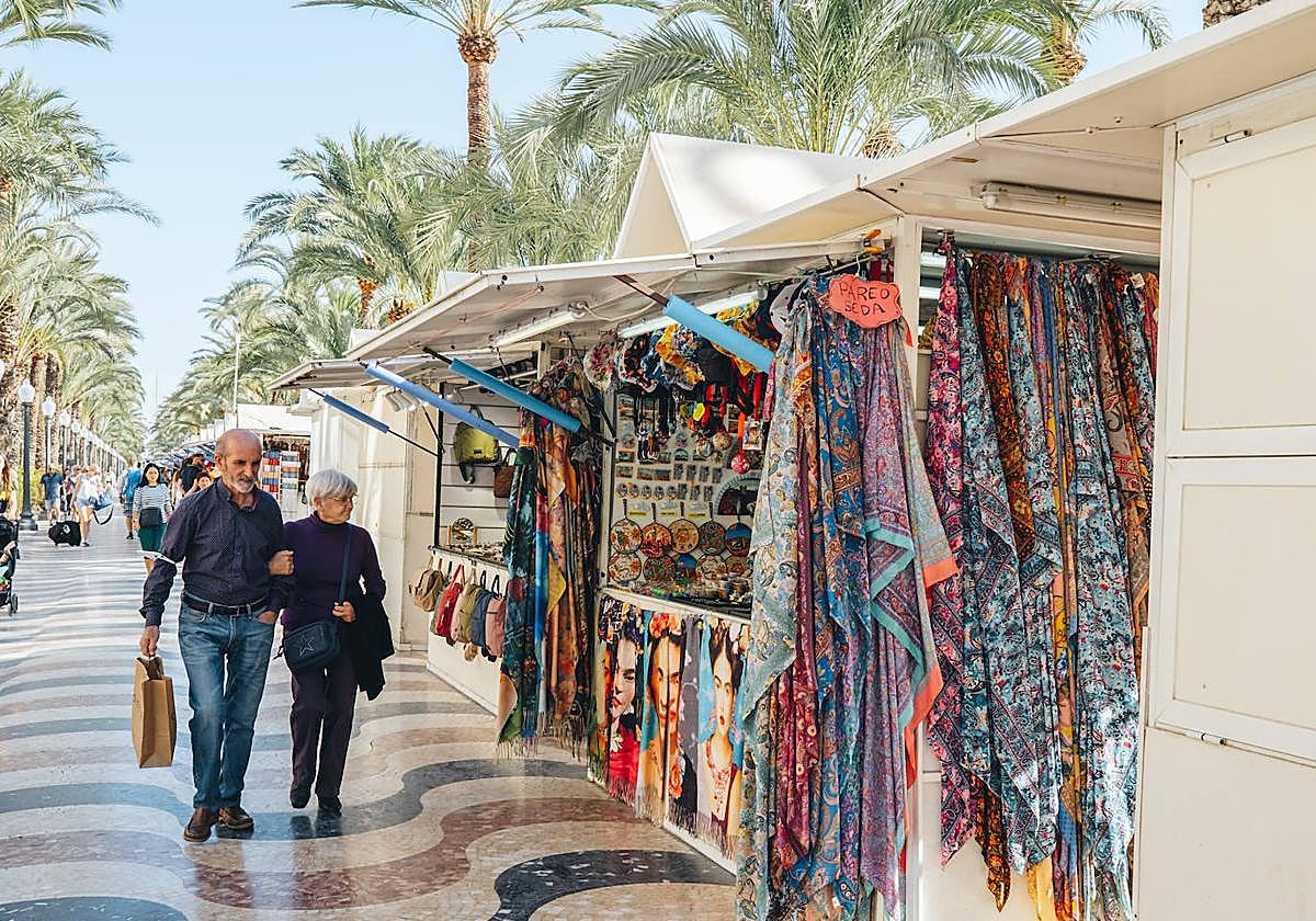 Turistas pasean por los hippies de la explanada.
