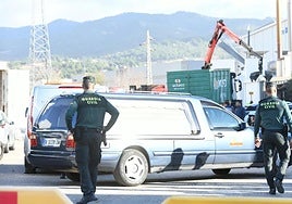 Un coche fúnebre abandona la zona de la fábrica.
