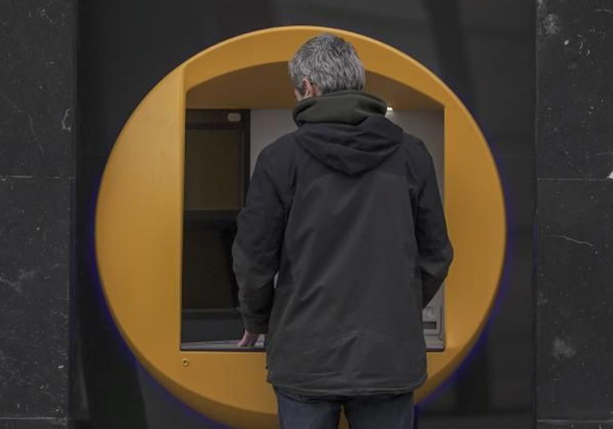 A man uses an ATM in a file image.
