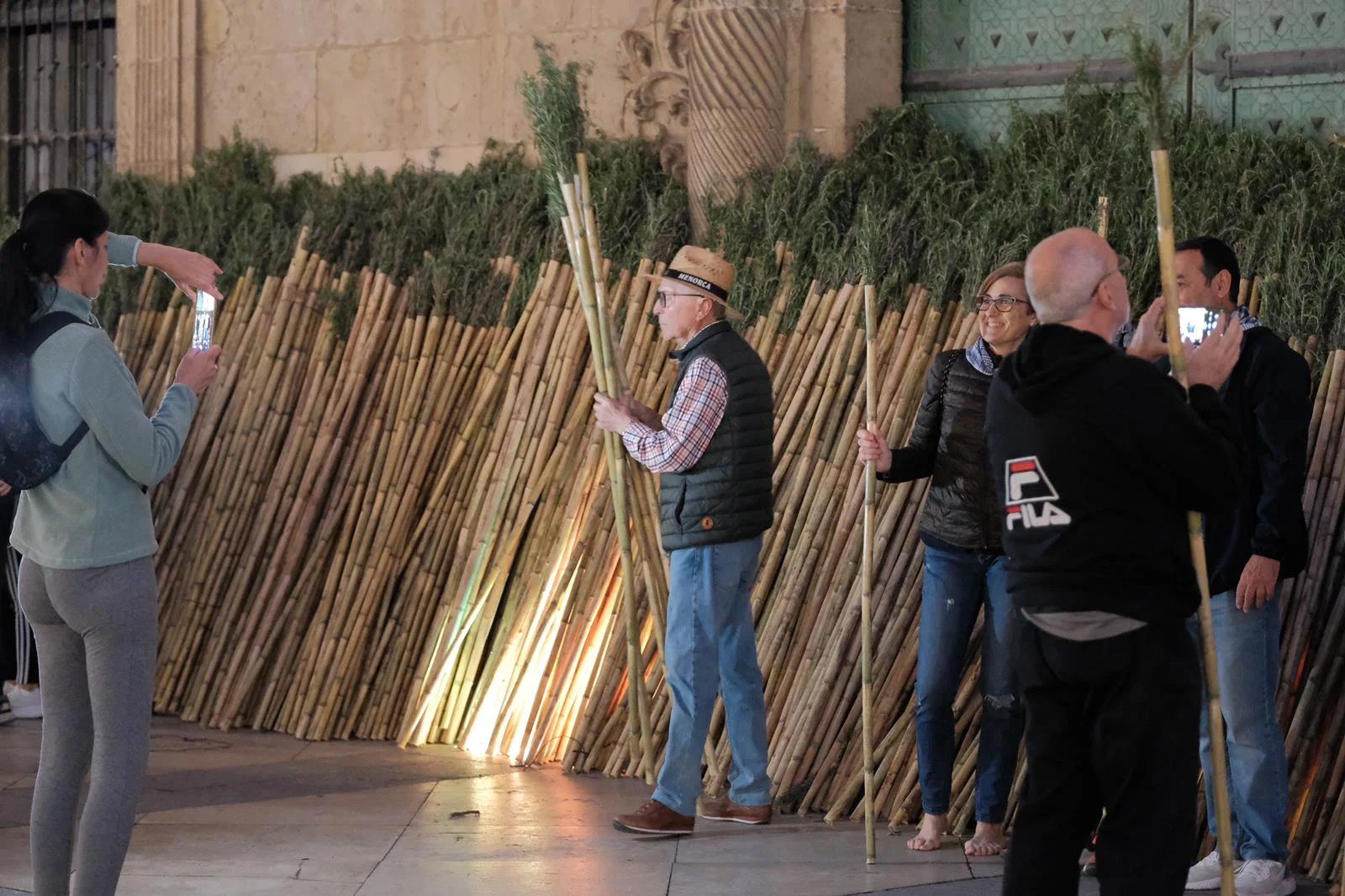 Several people collect canes at the Town Hall entrance.