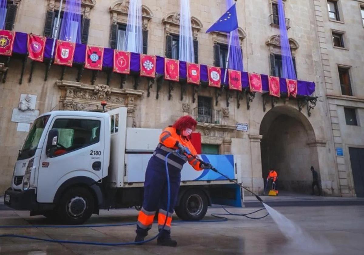 A cleaning worker operates in Alicante's Town Hall square.