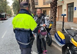 A Local Police officer with an electric scooter user.