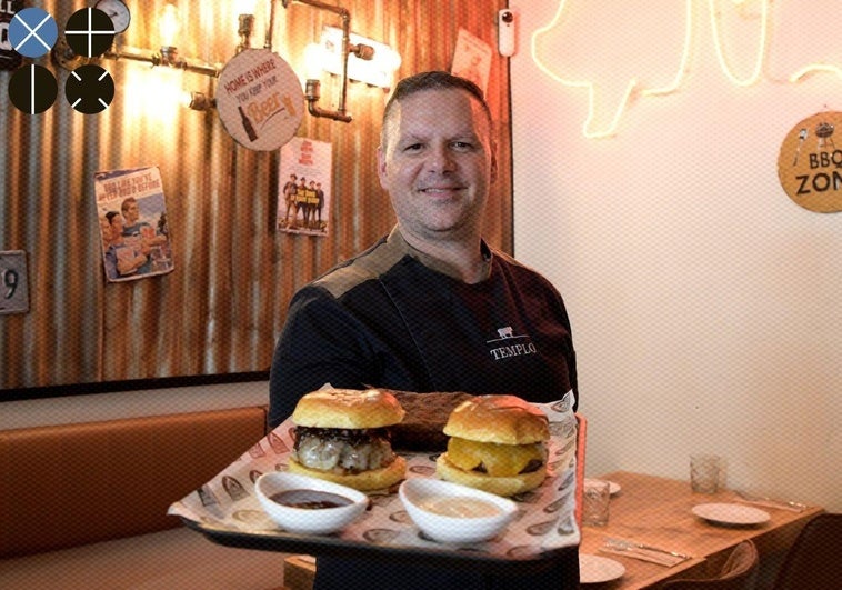 Ángel García with two of his burgers.