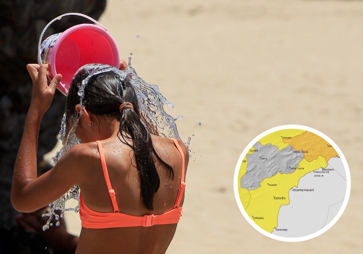 A girl pours water over herself to combat the heat.