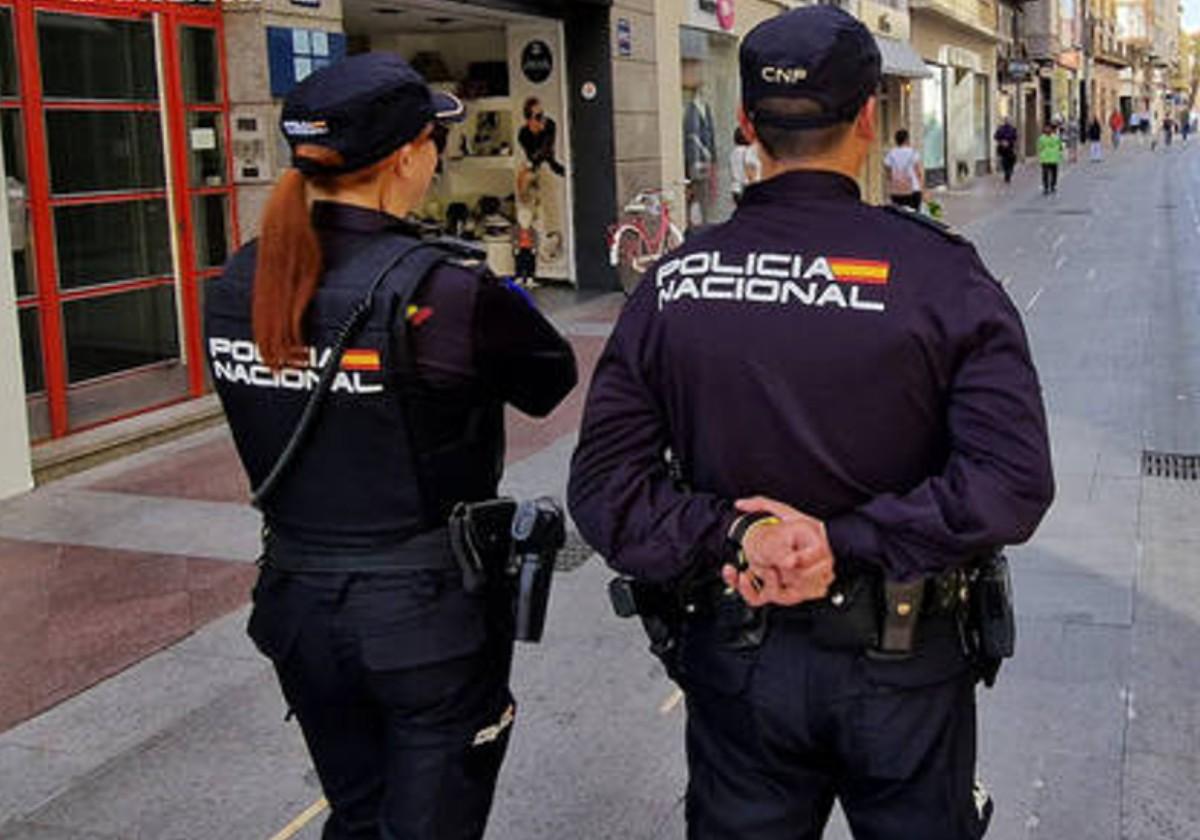 Dos policías nacionales patrullan por las calles de Elche.