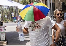 Un hombre con un gorro sombrilla durante la ola de calor.