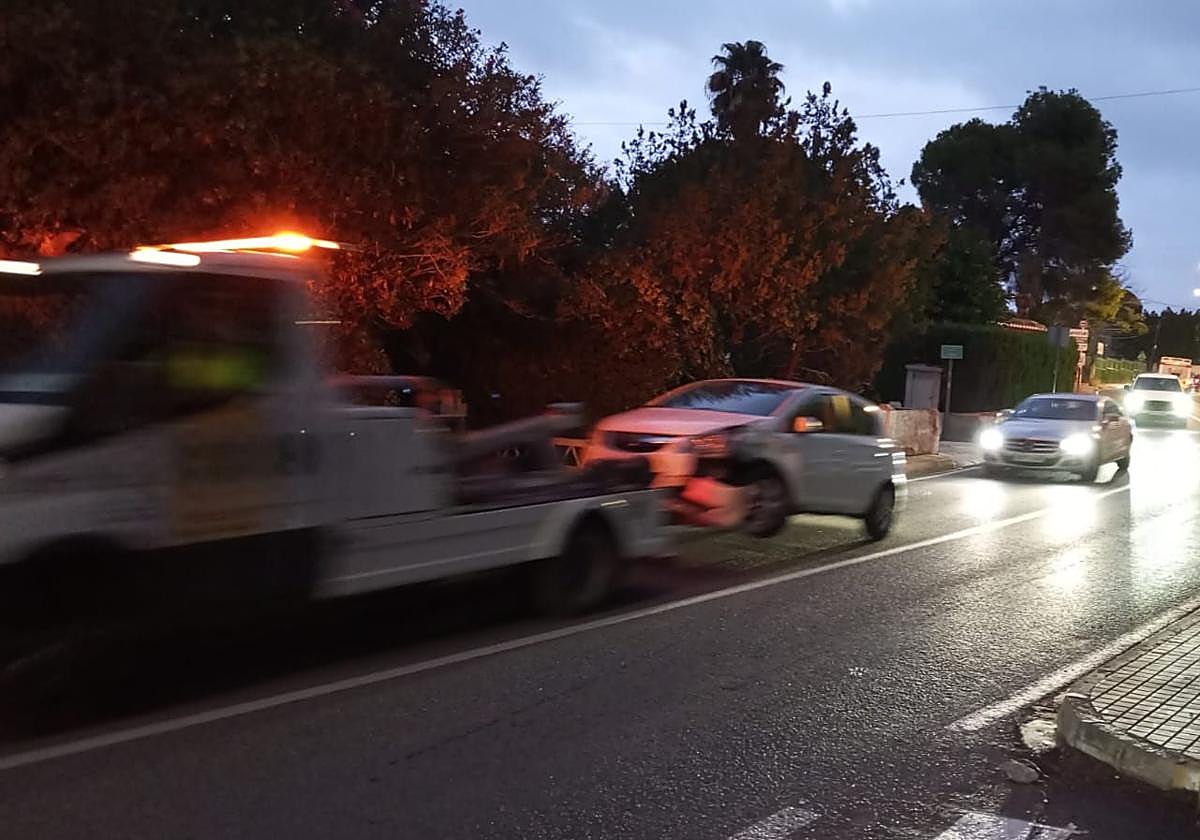 The crane removes one of the vehicles.