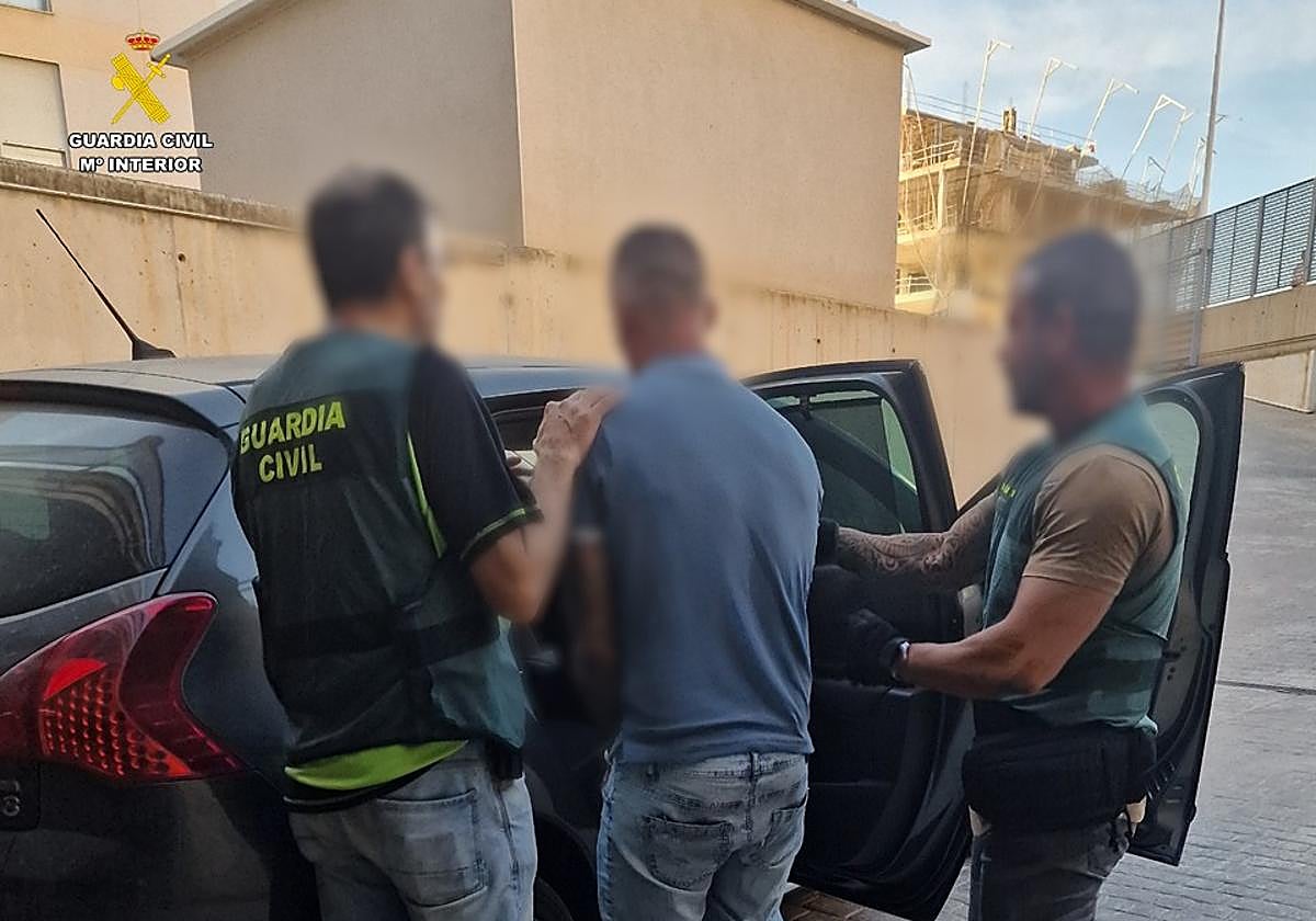 Civil Guard officers escort the detainee as the alleged shooter.