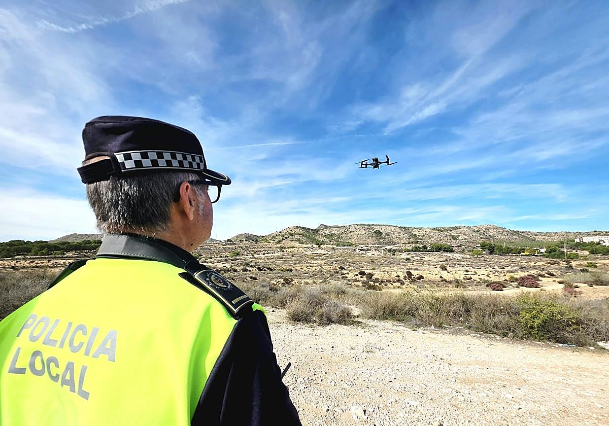 A Local Police officer pilots a drone.