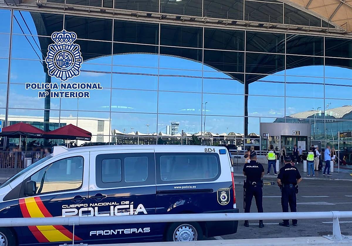 Two police officers monitor the entrances to Alicante-Elche airport.