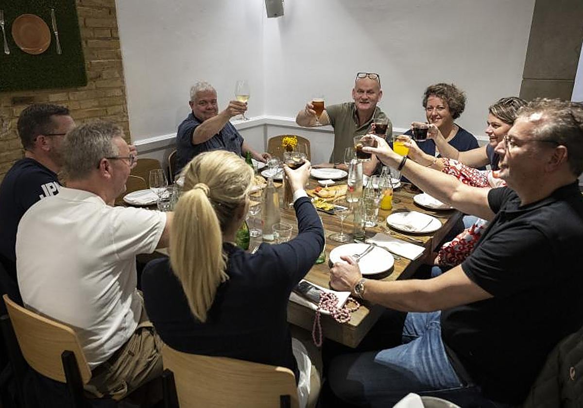 Colleagues celebrate Christmas early at a company dinner.