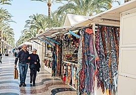 Turistas pasean por los hippies de la explanada.