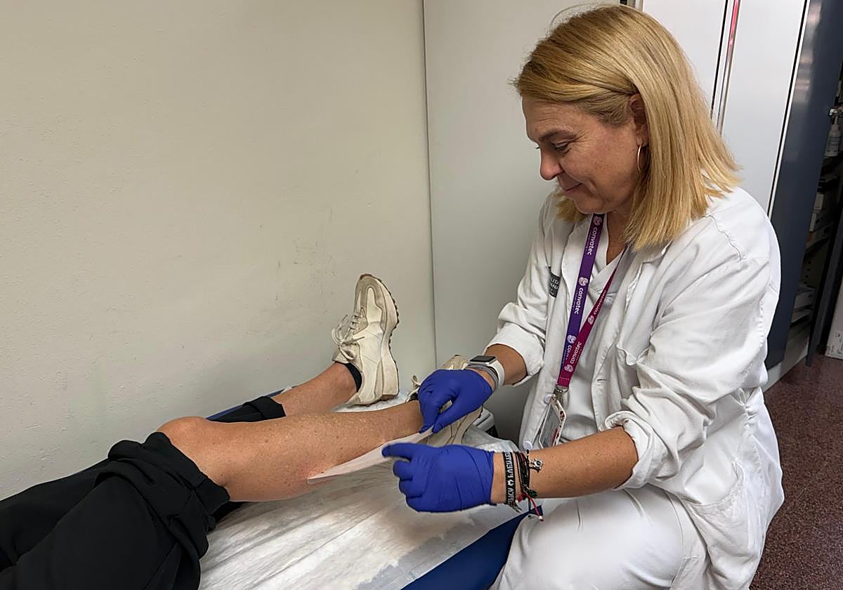 Nurse attending to a complex wound.